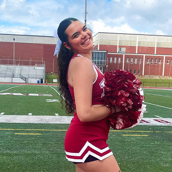 Mackenzie Vajda stands out on the football field in her cheerleading uniform at Indiana University of Pennsylvania.