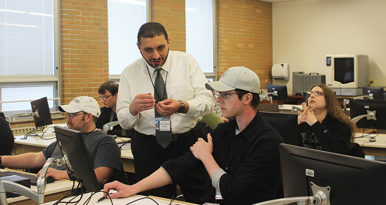 Waleed Farag teaches cybersecurity students in a classroom at Indiana University of Pennsylvania